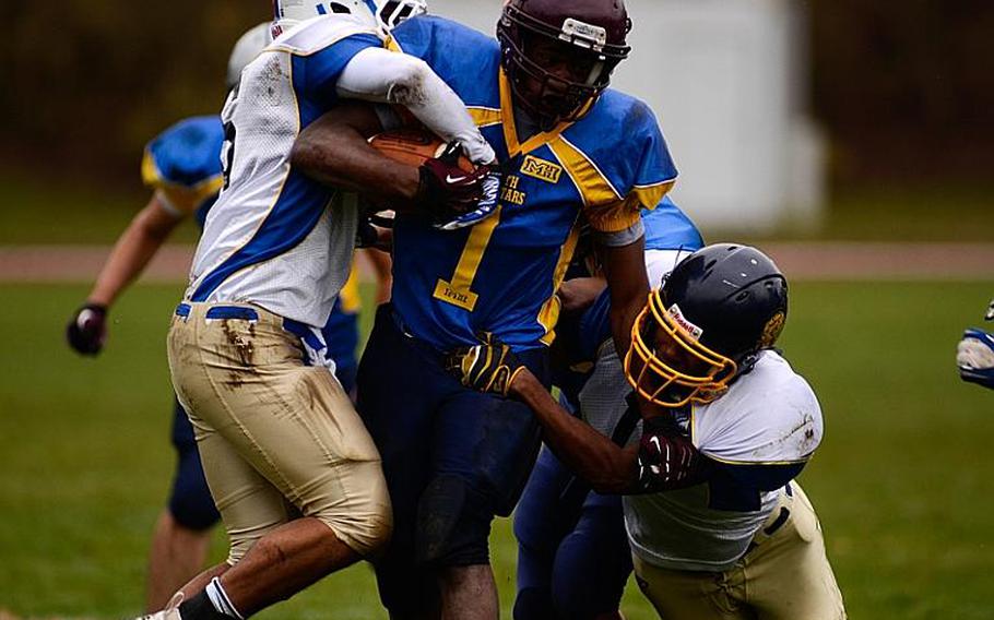 DODDS-Europe South All-Star football team member  Carlton Campbell of Vilseck High School drags a couple of North All-Star team defenders downfield Saturday afternoon in Vilseck, Germany as the South All-Stars defeated the North 29-10.