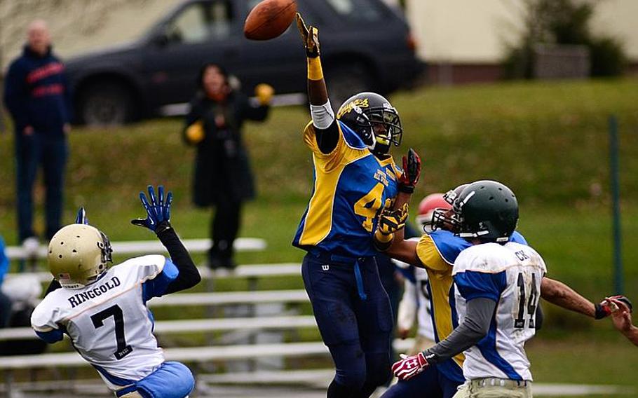 DODDS-Europe North All-Star football team member  Dennis Ringgold, far left, of Wiesbaden High School moves into position to catch a tipped pass Saturday afternoon in Vilseck, Germany as the South All-Stars defeated the North 29-10.