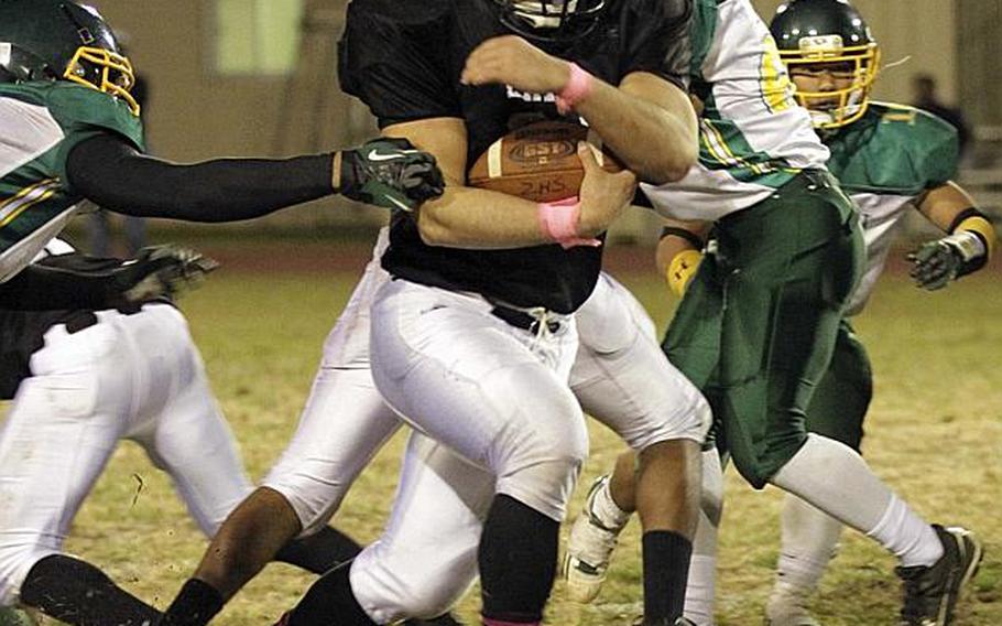 Zama American running back Andre Encarnacion plows his way through Robert D. Edgren defenders during Saturday's DODDS Pacific Far East High School Division II football championship game at Camp Zama, Japan. Zama beat Edgren 35-20 for its second D-II title in four years.