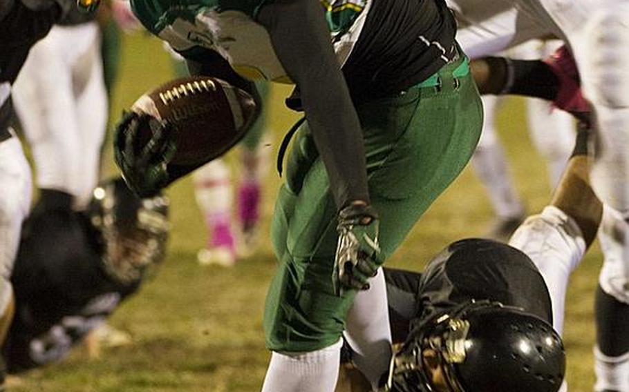 Robert D. Edgren running back Louis Murphy drags a Zama American defender into the end zone during Saturday's DODDS Pacific Far East High School Division II football championship game at Camp Zama, Japan. Zama beat Edgren 35-20 for its second D-II title in four years.