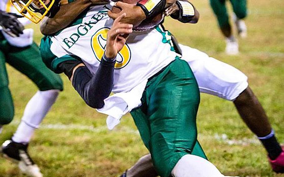 Robert D. Edgren ball carrier Tristan Jefferson gets tackled by Zama American  defender Rayvaughn King during Saturday's DODDS Pacific Far East High School Division II football championship game at Camp Zama, Japan. Zama beat Edgren 35-20 for its second D-II title in four years.