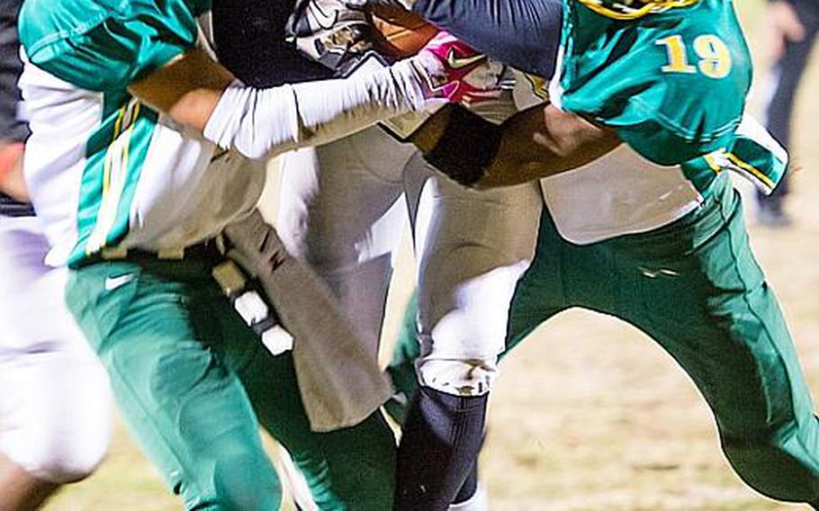 Zama American running back Mitchell Harrison gets sandwiched by Robert D. Edgren defenders Tyrone Bacalso and Ben Warren during Saturday's DODDS Pacific Far East High School Division II football championship game at Camp Zama, Japan. Zama beat Edgren 35-20 for its second D-II title in four years.