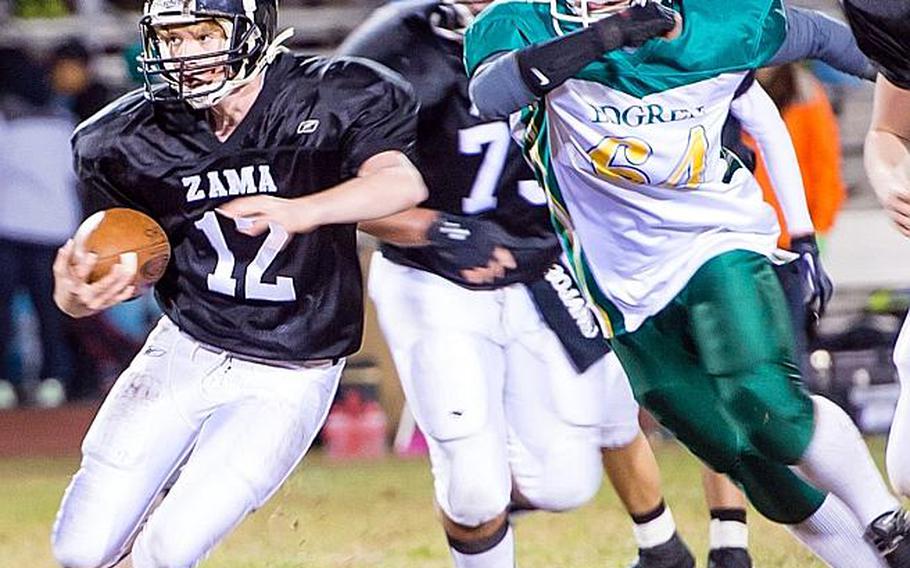 Zama American quarterback Nick Zeagler tries to evade the tackle of Robert D. Edgren defender Spencer Robison during Saturday's DODDS Pacific Far East High School Division II football championship game at Camp Zama, Japan. Zama beat Edgren 35-20 for its second D-II title in four years.