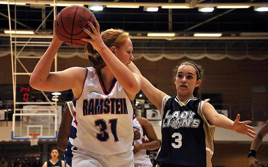 Ramstein's Katherine Enyeart looks to pass the ball to a teammate as Heidelberg's Kylee Miller defends during last season's Division I championship game in Wiesbaden, Germany in February. Both players will be back for their teams when the 2012-13 DODDS-Europe basketball season gets under way Friday.