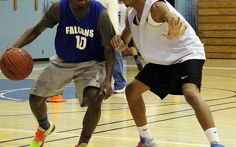 Junior Darien Briggs tries to dribble past senior Rashawn Wong during Tuesday's Seoul American Falcons boys basketball practice at Seoul American High School, South Korea.