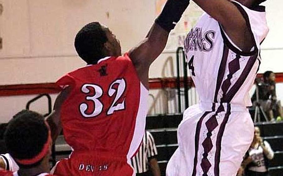Zama American's Parish Jones, right, shoots over Nile C. Kinnick's Dymond Simmons and Akisch Davis, left, during Tuesday's DODDS Japan and Kanto Plain Association of Secondary Schools boys basketball game at Camp Zama, Japan. Kinnick won the inter-division game 58-45.