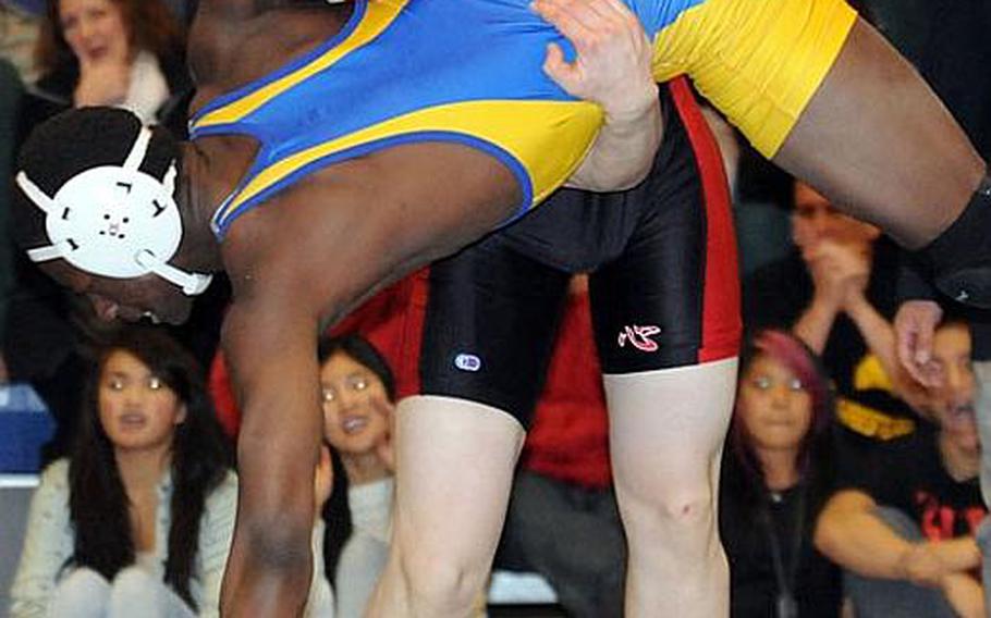 Nile C. Kinnick 180-pounder Aaron Stravers executes a three-point throw on St. Mary's International's Jeff Ogutu during last year's Division I dual-meet championship bout in the 35th Far East High School Wrestling Tournament. Stravers, now a senior, transferred to Okinawa over the summer and will wrestle at 180 pounds for the Kubasaki Dragons, the most decorated Division I team in Far East tournament history with 21 team titles.