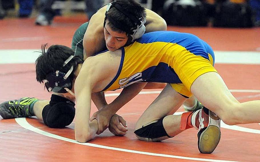 Kubasaki's Steven Walter gets the upper hand on St. Mary's International's Kaimi Miyazawa during last year's 108-pound gold-medal bout in the 35th Far East High School Wrestling Tournament. Walter is back in Kubasaki's lineup, seeking a three-peat, and will wrestle at 115 pounds.