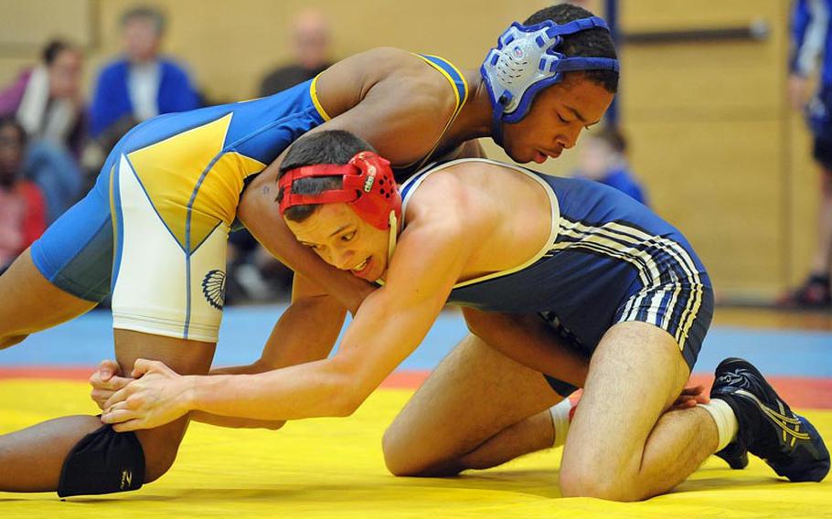 Wiesbaden's Dante Thomas, left, and Ramstein's TJ Moore grapple in the 132-pound final at an opening day meet in Wiesbaden as the 2012-13 DODDS-Europe season got under way.