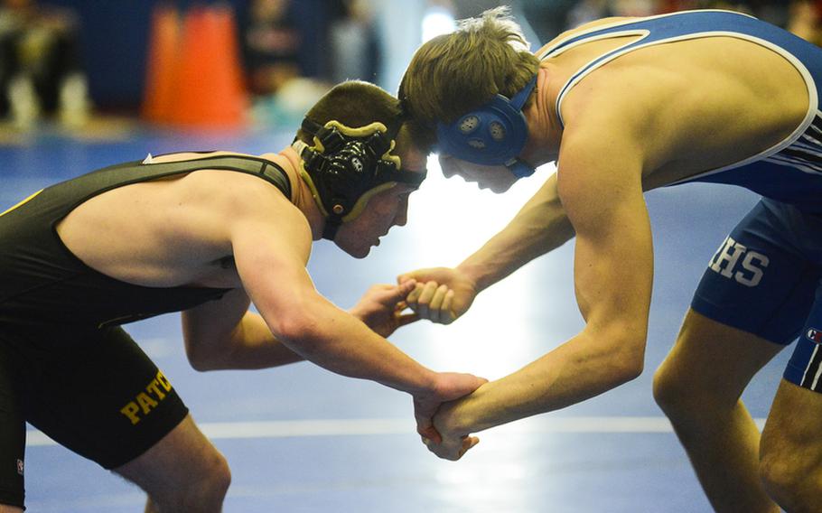 Patch High School's Connor Hartzell, left, and Galen McCarver of Ramstein High School lock hands in a 170-pound match Saturday morning at Ramstein Air Base, Germany in a DODDS-Europe wrestling meet.