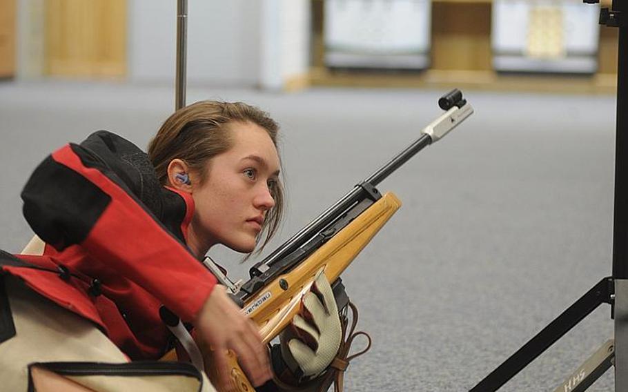 Patch's Maggie Ehmann checks the scoreboard between shots during marksmanship practice Wednesday at Patch High School. Scores at practice determine who competes in the upcoming match.