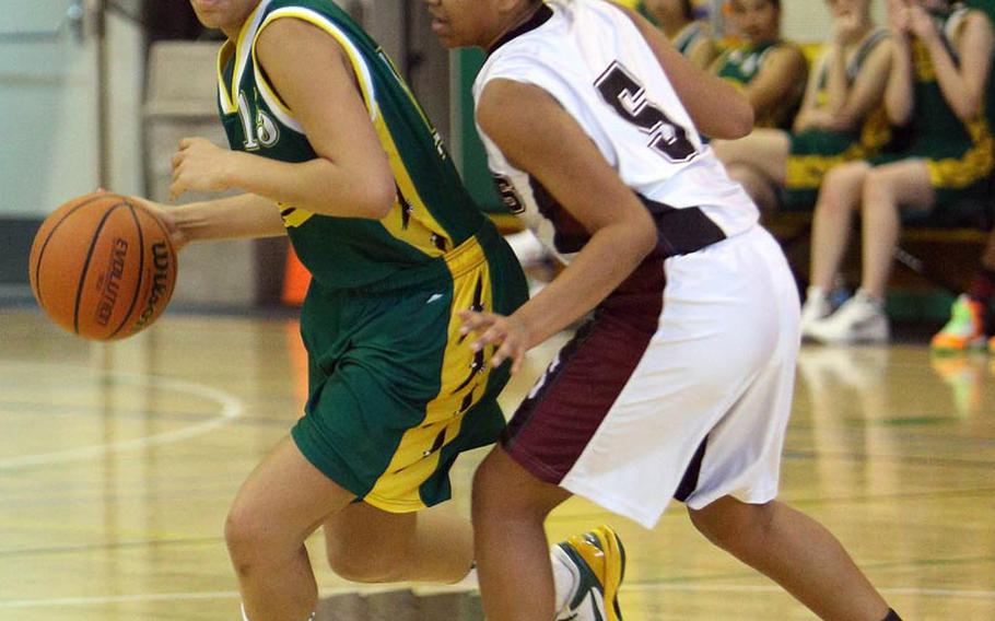 Robert D. Edgren's Alexis Farrow dribbles against Zama American's Lamari Harris during Saturday's DODDS Japan high school girls basketball game at Misawa Air Base, Japan. The Trojans beat the Eagles 35-32 in overtime to salvage a split of the weekend series.