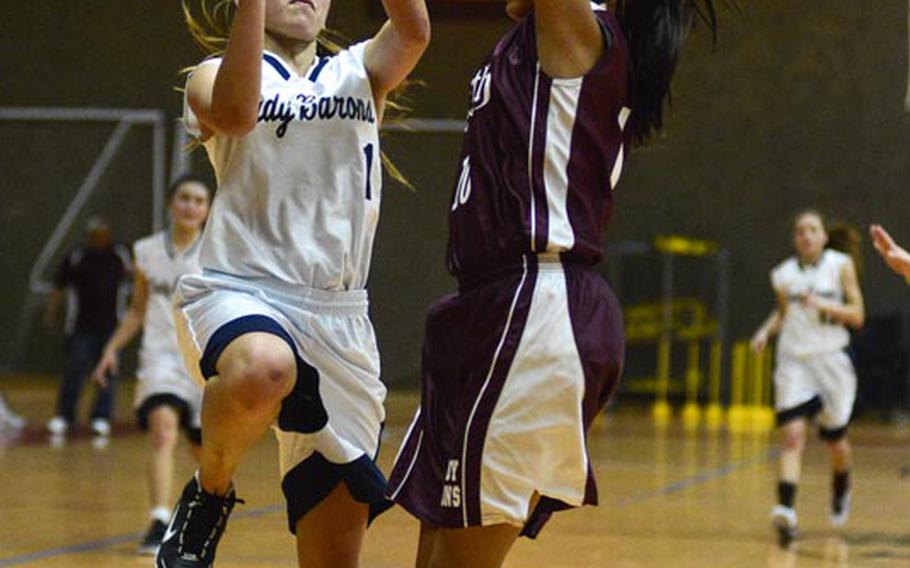 Bitburg High School's Dawn Valbuena lays the ball up for two, just squeaking by AFNORTH High School's Keylee Soto-Camacho in Saturday morning's game at Spangdahlem Air Base, Germany. Bitburg went on to defeat AFNORTH 39-31.