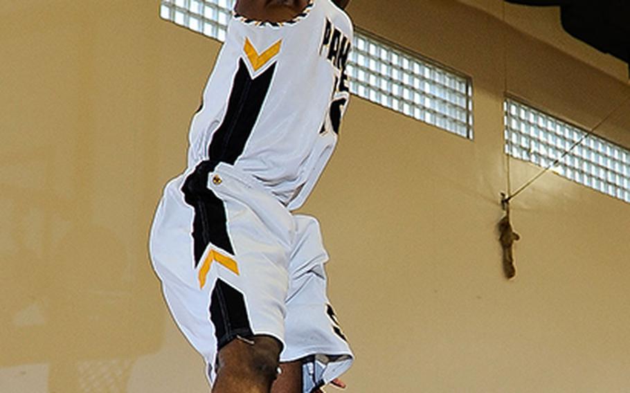 Kadena's Preston Harris goes up for a slam dunk against Oroku during Sunday's boys championship game in the 7th Okinawa-American Friendship Basketball Tournament at Kadena Air Base, Okinawa. Kadena defended its title 65-64 in overtime.