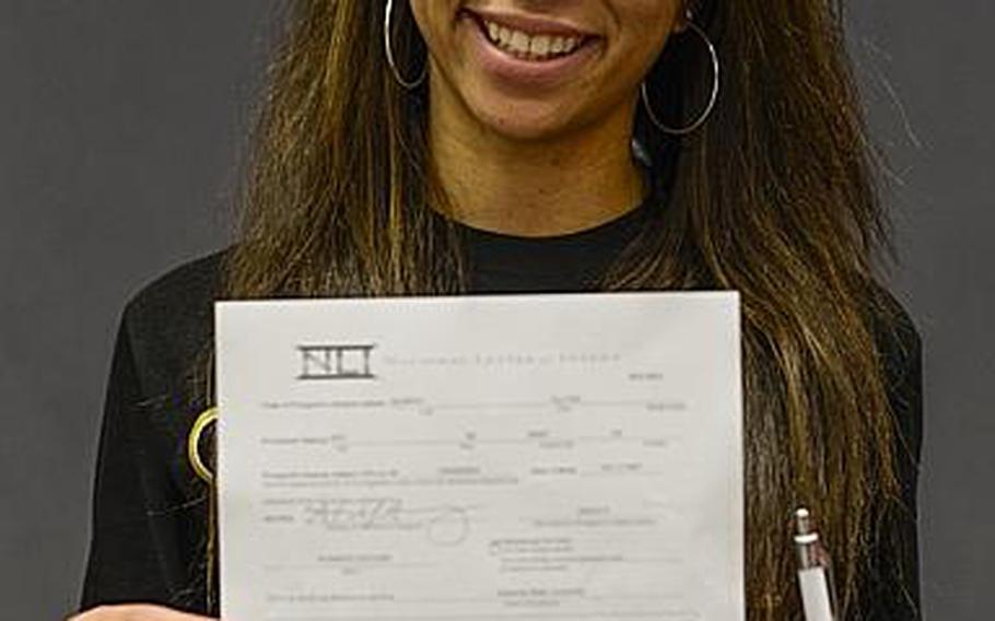 Kaiserslautern senior Ally Murphy poses for a photograph after signing a national letter of intent to play for Alabama State University, an NCAA Division I program in Montgomery, Ala., in the Kaiserslautern High School gym Tuesday morning.