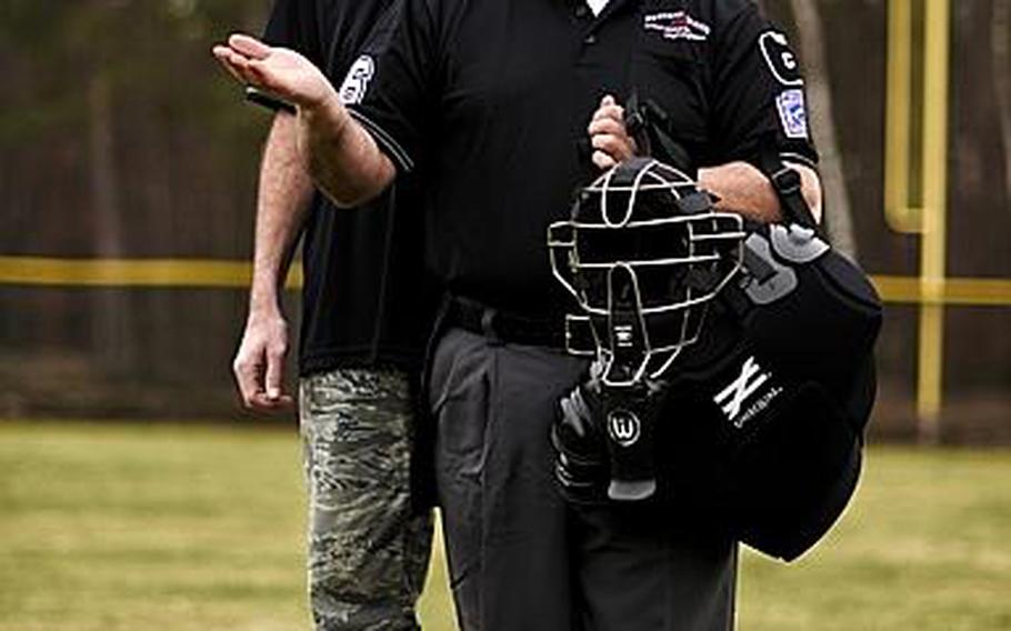 In a pose inspired by Norman Rockwell's "Game Called Because of Rain" John Valverde, front, a retired airman and civilian with Ramstein's 86th Communications Squadron, has been chosen to umpire at the Junior League World Series. The event, set for Aug. 11-17 at Taylor, Mich., features 13-14 year olds. Senior Master Sgt. Jeff Bise, meanwhile, will work the Big League World Series July 24-31 at Easley, S.C.