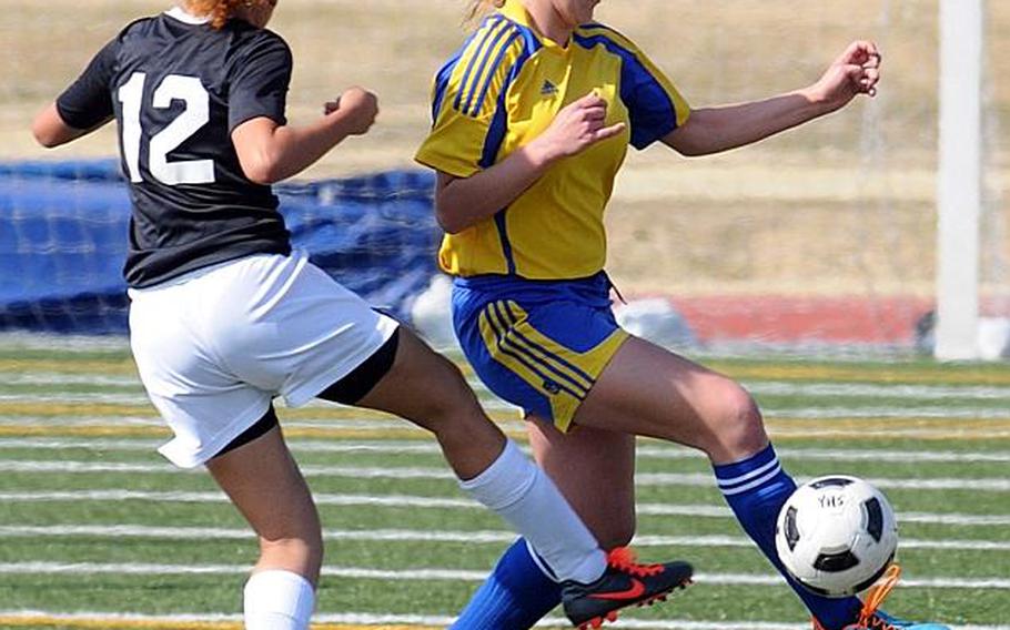 Kadena's Adia Threatt and Yokota's Sarah Claypool battle for the ball during a soccer friendly at Yokota Air Base, Japan. Yokota edged Kadena 2-1. Claypool is a sophomore midfielder who transferred from Germany last summer and has helped lead Yokota to a 6-1-2 record with six shutouts and a 17-3 goal differential in nine matches.