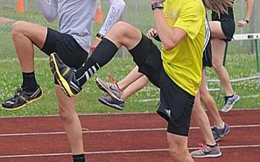 Former and present Far East cross-country champions, Kubasaki Dragons Erik Armes (Division I, 2011) and senior Ryan Bugler (Division II, 2012) go through warmups Wednesday at Camp Foster, Okinawa. The two help form a formidable group of distance runners who've helped the Dragons remain unbeaten so far this track and field season.