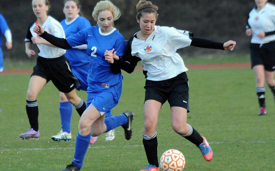 Aleeza Vitale of Brussels and AFNORTH's Samantha Stanton battle for the ball in a game at AFNORTH last month. This weekend Brussels will join Rota and Menwith Hill at Alconbury while AFNORTH heads to SHAPE.