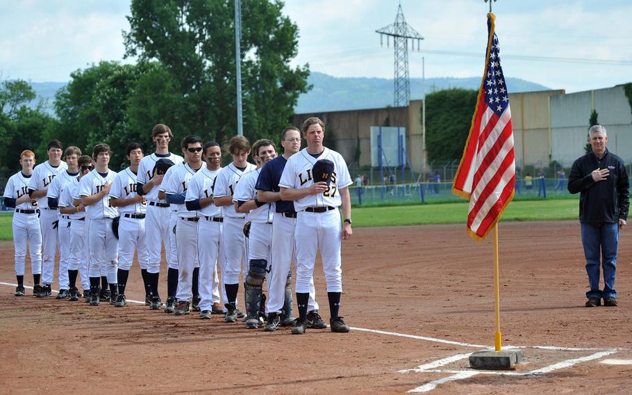 The Heidelberg Lions baseball team listen to the national anthem before the team's final home games ever against Hohenfels. At right is USAREUR commander Lt. Gen. Donald Campbell Jr., who threw out the ceremonial first pitch Saturday.
