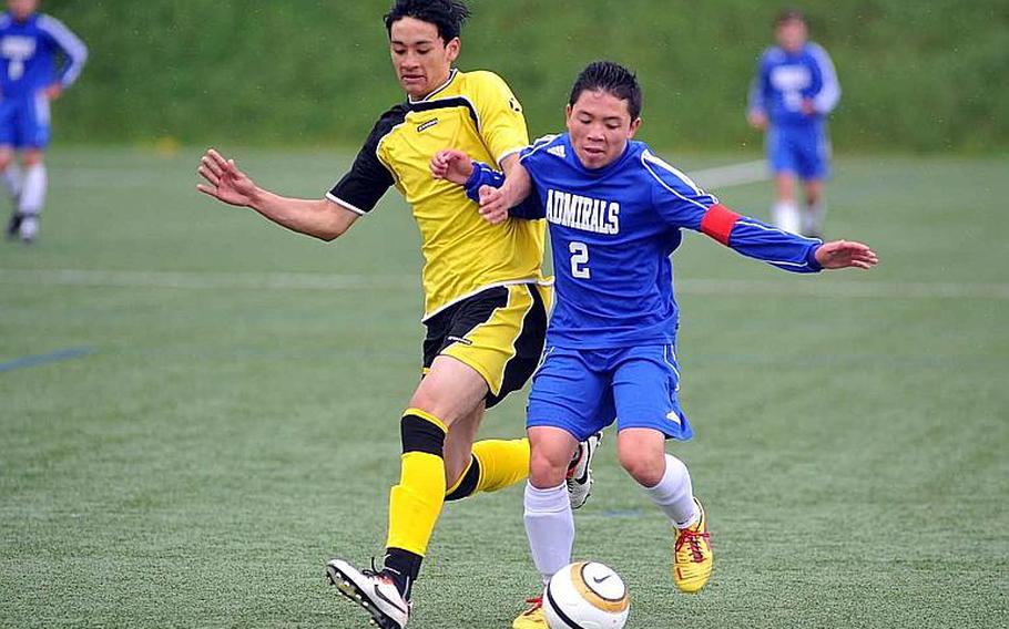 Alconbury's Thomas Luong, left, tries to slow down Rota's Kenneth Rios in their opening day Division III match at the DODDS-Europe soccer championships Monday. Alconbury won 2-1.