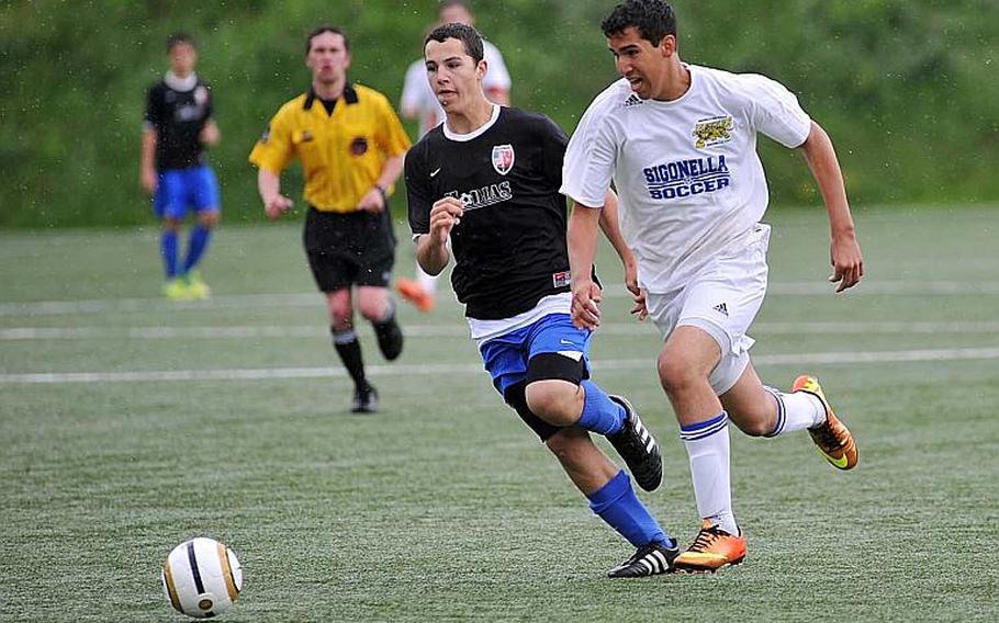 Sigonella's Antonio Garcia-Diaz, right, races Incirlik's Eli Spencer for the ball in their Division III game on opening day of the DODDS-Europe soccer championships. Sigonella won 5-1.