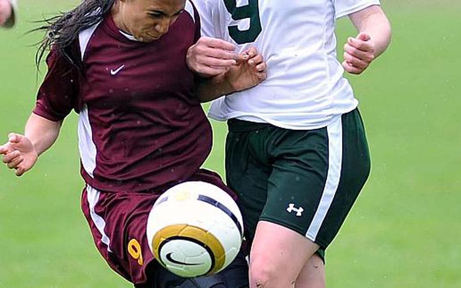 Baumholder's Karina Inchauregui, left, and Alconbury's Joely Womack collide during opening day Division III action at  the DODDS-Europe soccer championships Monday. Alconbury won 5-0.