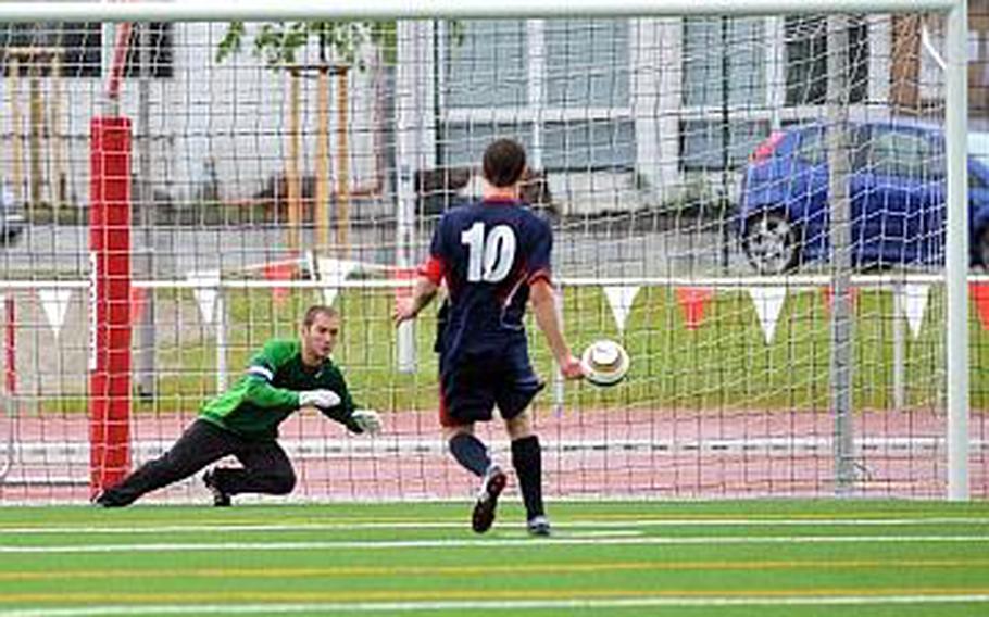 Hohenfels goalie Andrew Becker leaps in the right direction to stop a shot by Aviano's Matthew O'Brien in a shootout won by Hohenfels 4-2 after the game ended 0-0 in regulation.