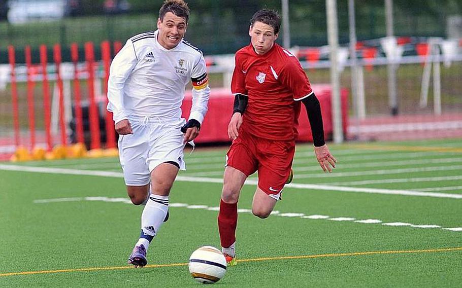 Heidelberg's Vinnie Harrington, left, and ISB's Lukas MacNaughton chase the ball in the Division I final at the DODDS-Europe soccer championships in Kaiserslautern, Germany, Thursday. ISB beat the Lions 3-1 to defend their division title.