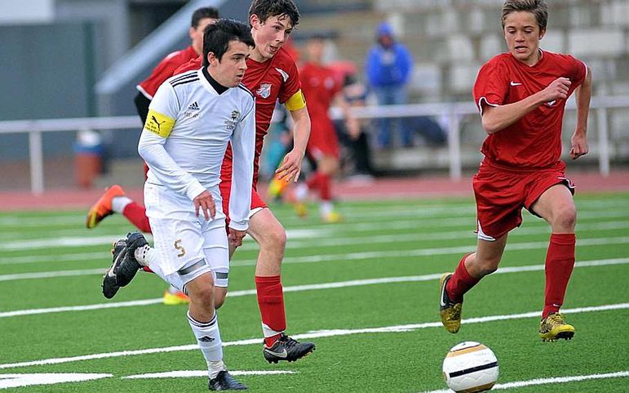 Heidelberg's Andrew Guelle, left, drives the ball up the field against ISB's Jack Willows, center, and Fred Jordaan in the Division I final at the DODDS-Europe soccer championships in Kaiserslautern, Germany, Thursday. ISB beat the Lions 3-1 to defend their division title.