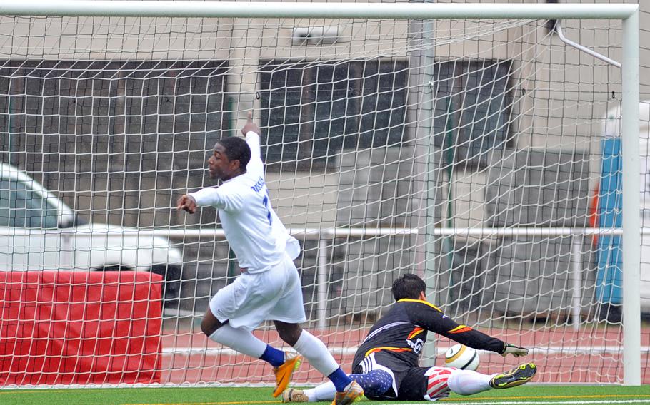 Kristian Javier of Brussels celebrates the second of his three goals in the Division III final at the DODDS-Europe soccer championships in Kaiserslautern, Germany, May 23, 2013, as the ball rolls past Menwith Hill keeper Damon Morris into the net. Brussels won the game 4-2. Javier has been named the Stars and Stripes boys soccer athlete of the year.