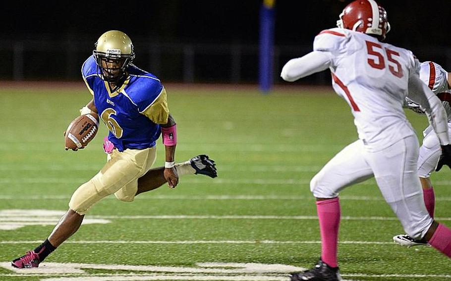 Wiesbaden's Reymoi Lewis keeps his eyes on Kaiserslautern's Tysean Hendrix as he carries the ball Friday in the Warriors 42-34  home win over the Raiders. The two teams are among those fighting for playoff positions in DODDS-Europe Division I football.