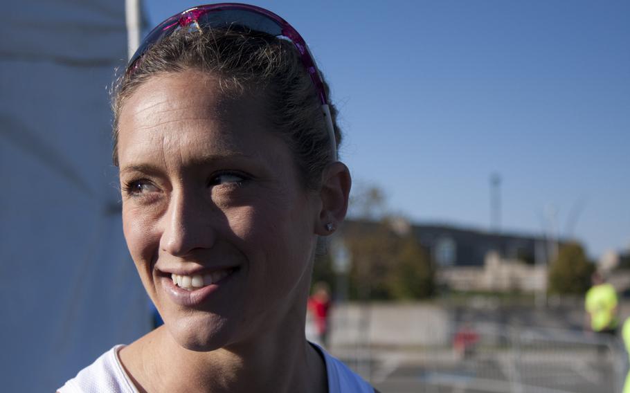 Army Capt. Kelly Calway speaks outside the Pentagon after finishing sixth in women's division in the 2013 Army 10-Miler on Oct. 20, 2013. Calway was the first military woman to finish this year's race and received a trophy, the first time race organizers were recognizing the accomplishment.