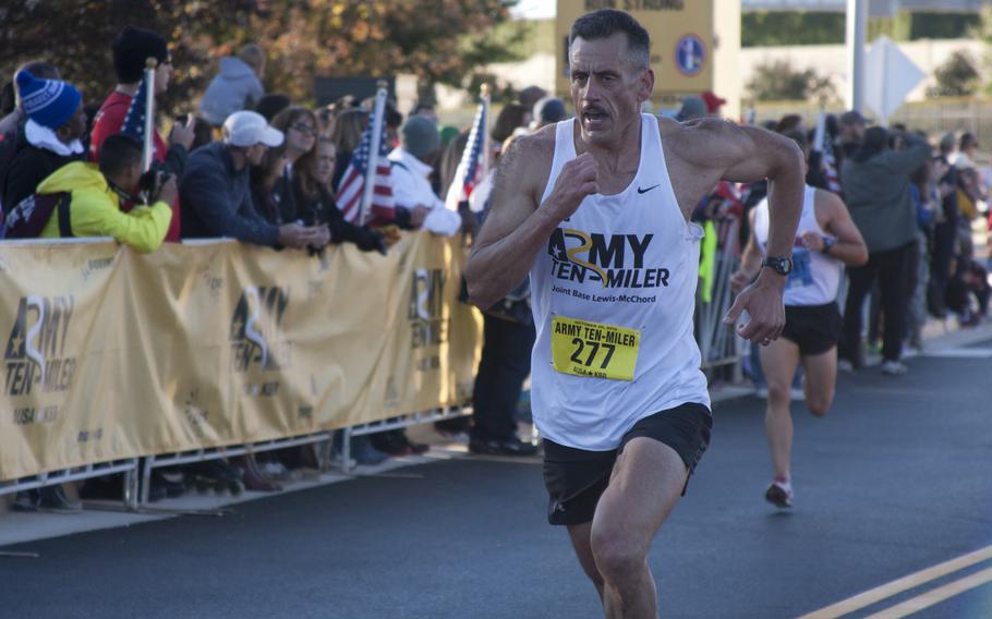 Runners cross the finish line of the 29th annual Army 10-Miler race outside the Pentagon on Oct. 20, 2013.