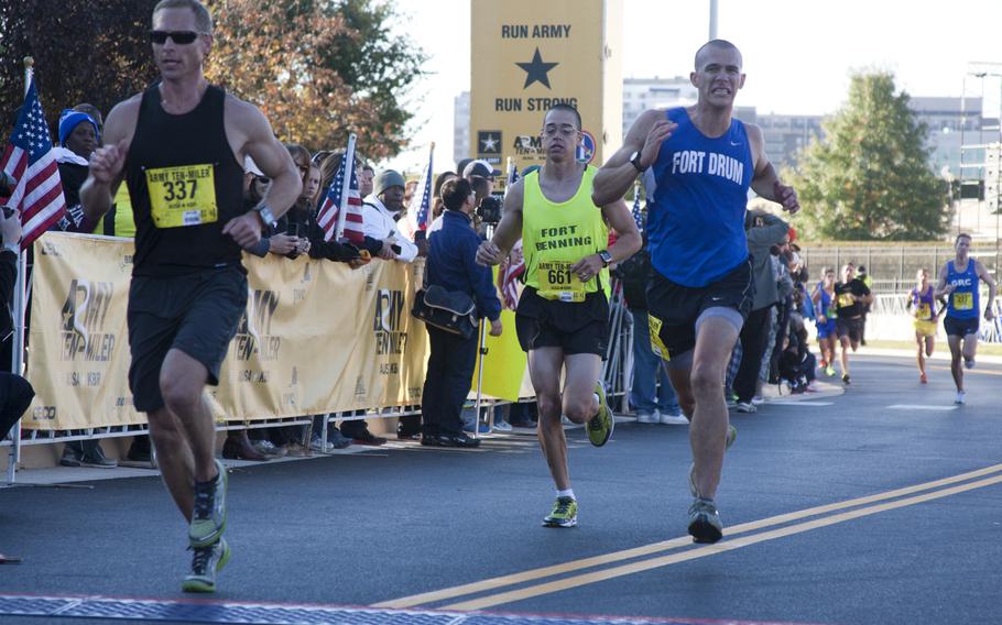 Runners cross the finish line of the 29th annual Army 10-Miler race outside the Pentagon on Oct. 20, 2013.