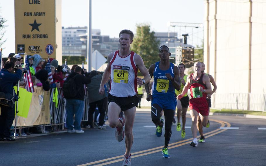 Runners cross the finish line of the 29th annual Army 10-Miler race outside the Pentagon on Oct. 20, 2013.