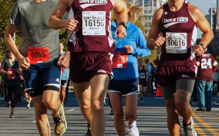 Caleb Runge (16156) and Brody Lester of Texas A&M  and Daniel Elias of Washington, D.C., in the Army 10-Miler, Oct. 20, 2013.