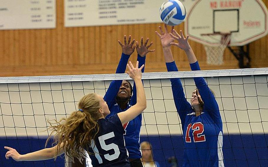 Lakenheath's Kristen Reed gets the ball over the Ramstein defense of Denee Lawrence and Chera Jensen in a match at Ramstein, Saturday, Oct. 12, 2013. The DODDS-Europe volleyball championships get under way at Ramstein and Kaiserslautern on Thursday, Oct. 31.