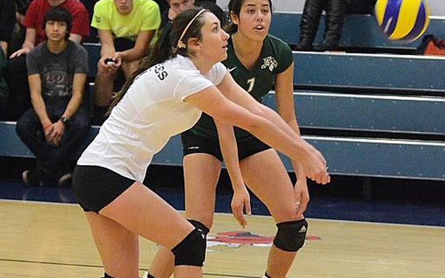 Naples volleyball player Carina Cusumano bumps the ball during a match against Aviano Saturday, Oct. 12, 2013, while teammate Victoria Krause watches at Aviano Air Base, Italy.  Naples won 25-21, 25-22 and 25-17. The DODDS-Europe volleyball championships get under way at Ramstein and Kaiserslautern on Thursday, Oct. 31.