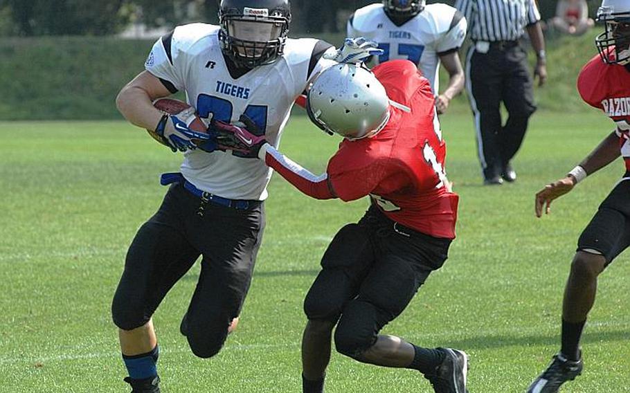 Hohenfels running back David Vidovic runs through a Schweinfurt/Bamberg tackle in Hohenfels' season-opening 38-14 victory at Schweinfurt, Germany. Vidovic scored four touchdowns on the day and leads the Tigers into Saturday's championship game.