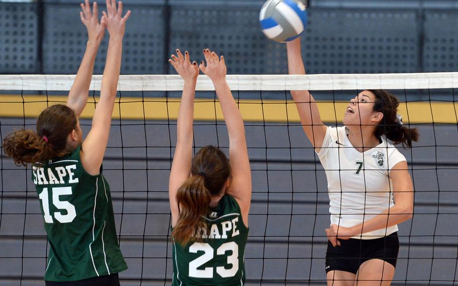 Victoria Krause of Naples, right, hits against SHAPE's Begona Rodriguez Bravo, left, and Maria Arevalo Narvaez at the DODDS-Europe volleyball championships in Ramstein, Germany, Oct. 31, 2013. Krause has been named the Stars and Stripes volleyball Athlete of the Year.