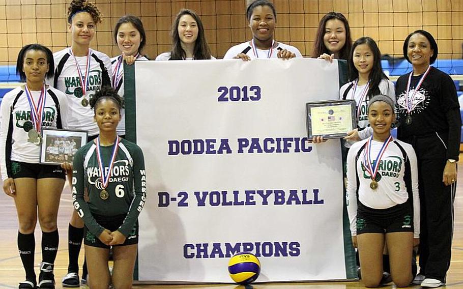 Members of Daegu girls volleyball team strike a pose with the team banner after Thursday's championship match against Zama American Trojans in the Far East High School Girls Division II Volleyball Tournament at Camp Zama, Japan. Daegu won the match 22-25, 25-13, 25-17, 25-16, its third title in five years and fourth overall, matching the DODDS record set by Zama in 1997. Clockwise from lower left are Kaylah Black, Rachel Wyche, Auburn Hood, Kaitlyn Nott, Lari Robertson, Taylor Myatt, Irene Malenky, Rose O'Houlahan, coach Joanna Wyche and Rheagan Wyche.