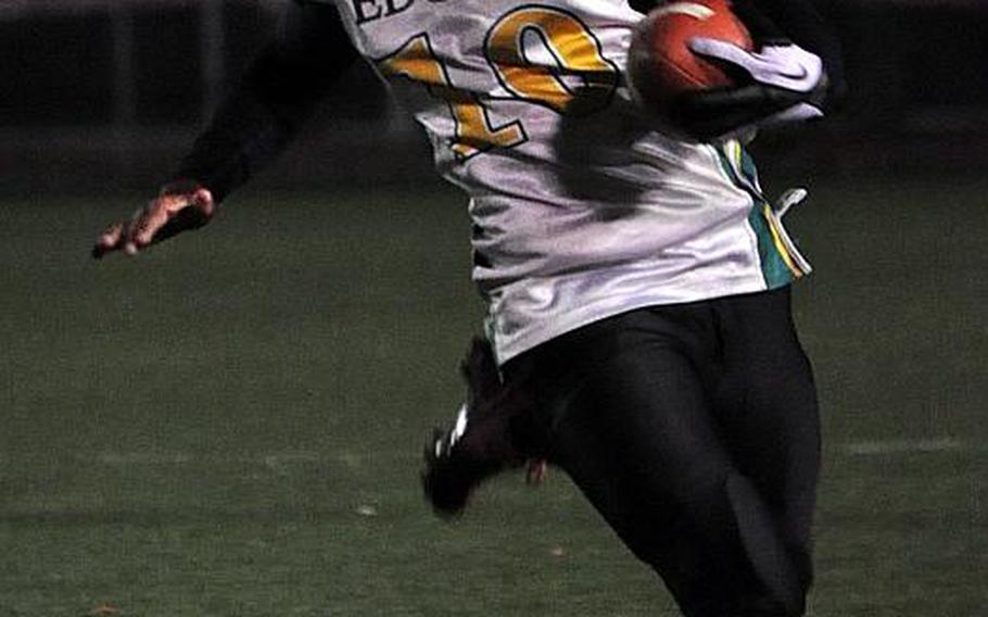 Robert D. Edgren quarterback Khaleem Shabazz runs for daylight against Daegu during Friday's Far East High School Division II football championship game at  Camp Walker, South Korea. The Warriors won 33-12..