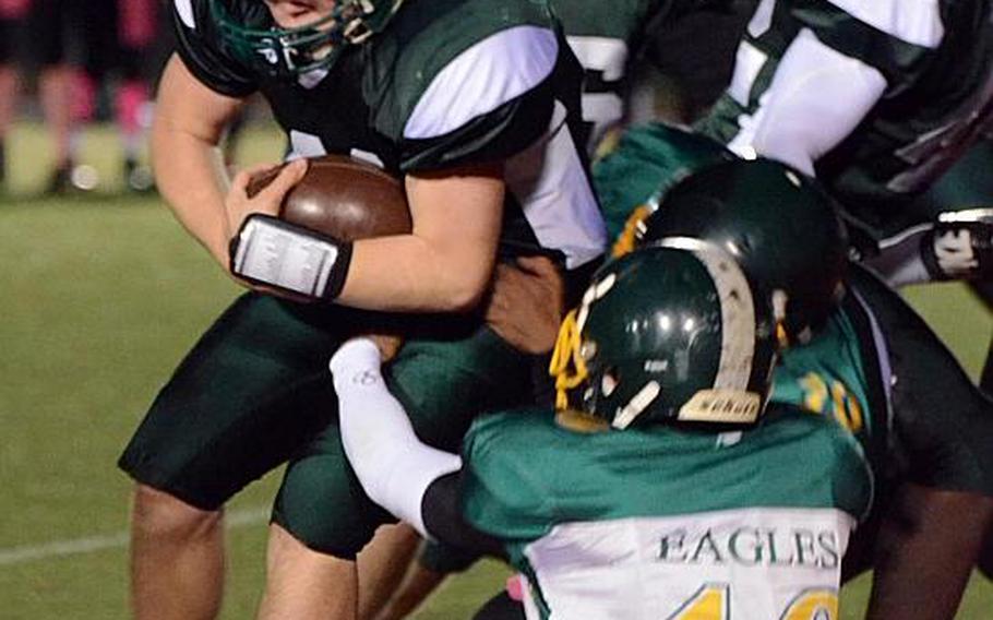 Taylor Mendenhall of Daegu tries to bull his way through  Robert D. Edgren defender Kaleb Atchison during Friday's Far East High School Division II football championship game at Camp Walker, South Korea. The Warriors won 33-12.