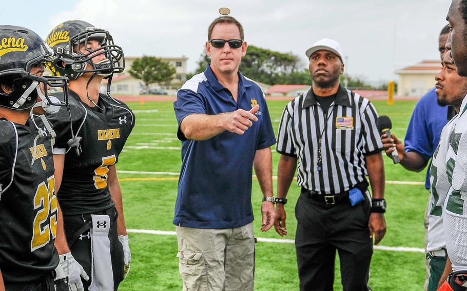 Air Force Brig. Gen. James B. Hecker makes the pre-game coin toss between captains of the Kadena Panthers and Kubasaki Dragons before Saturday's DODDS Pacific Far East High School Division I football championship game at Kadena Air Base, Okinawa. Kadena won the toss and chose to receive; Kubasaki won 34-31 in overtime.