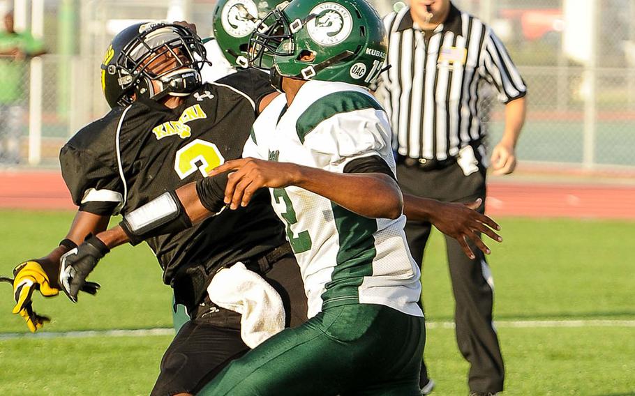 Kadena running back Barry Mitchell tries to outrun Kubasaki defenders Devean Curtis and DeQuan Alderman for the ball during Saturday's DODDS Pacific Far East High School Division I football championship game at Kadena Air Base, Okinawa. Kubasaki beat Kadena 34-31 in overtime.