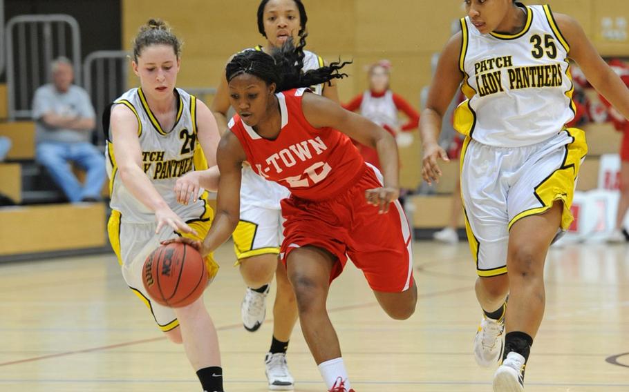 Kaiserslautern's Alana Dickerson drives the ball up the court against the Patch defense of Jenny Sparks,Treshon Jenkins and Breanna Rodriguez in a Division I semifinal at the DODDS-Europe Basketball Championships in Wiesbaden, Germany, in February. Dickerson will be returning for the Raiders this season as the team tries to defend the Division I title.