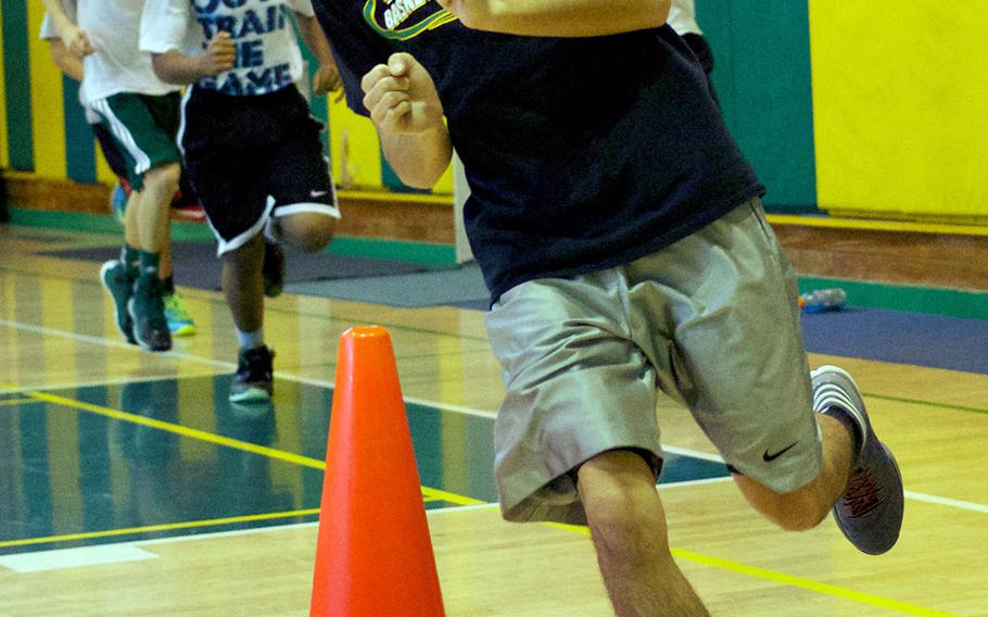 Senior guard Izzy Leon rounds a cone during Wednesday's Robert D. Edgren Eagles basketball practice.