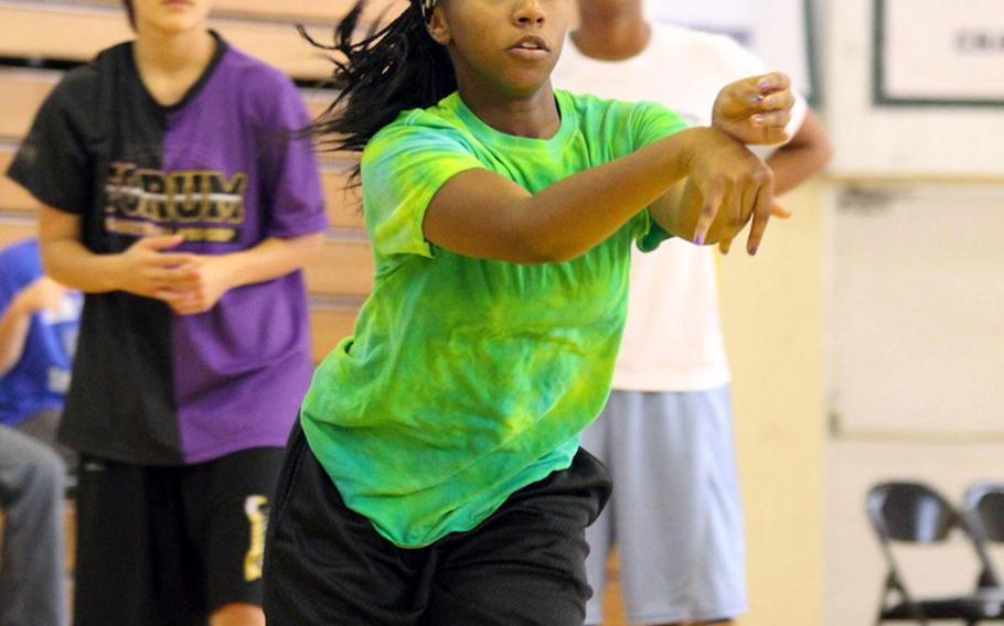 Kadena junior Desmon Reed dishes off a pass during Thursday's practice.