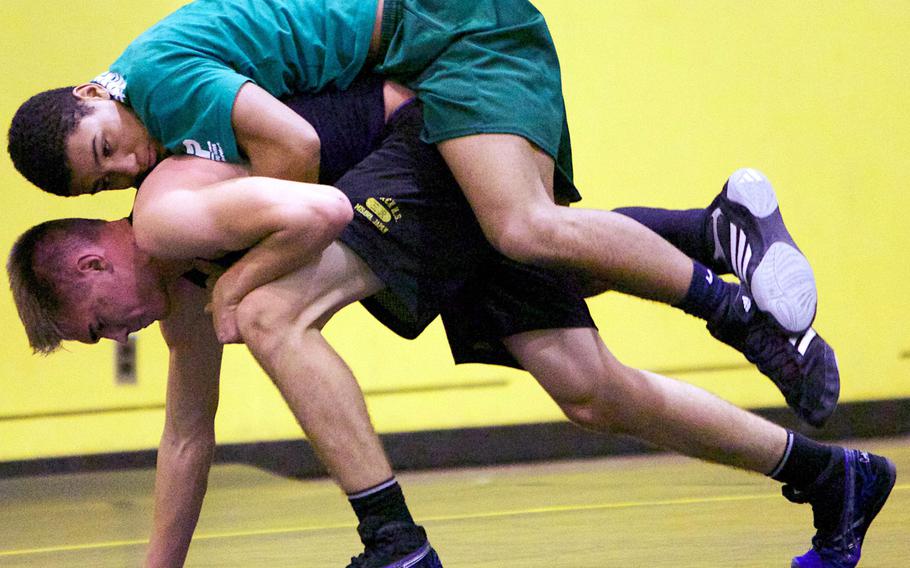 Robert D. Edgren senior Kaleb Atchison and sophomore Sky Phillips work out during practice on Wednesday.